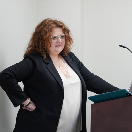 Staff member speaking from a podium