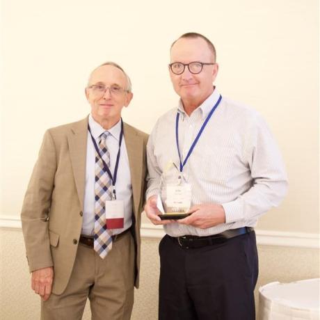 Tom Morris awarding the 2025 Calico Quality Leadership Award to John Packham