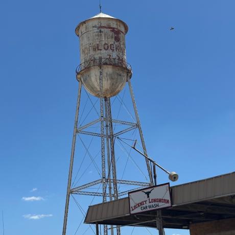 Old water tower set against blue sky